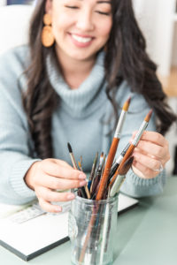 Prop photo of girl with paint brushes