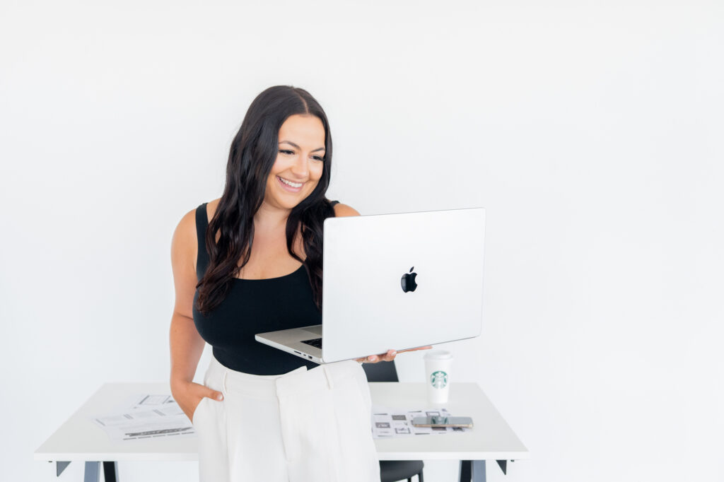 Business owner holding her laptop. A Brand Session with a Social Media Manager Concord Brand Photographer 